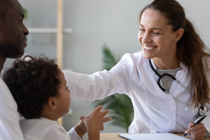 woman doctor smiling with patients